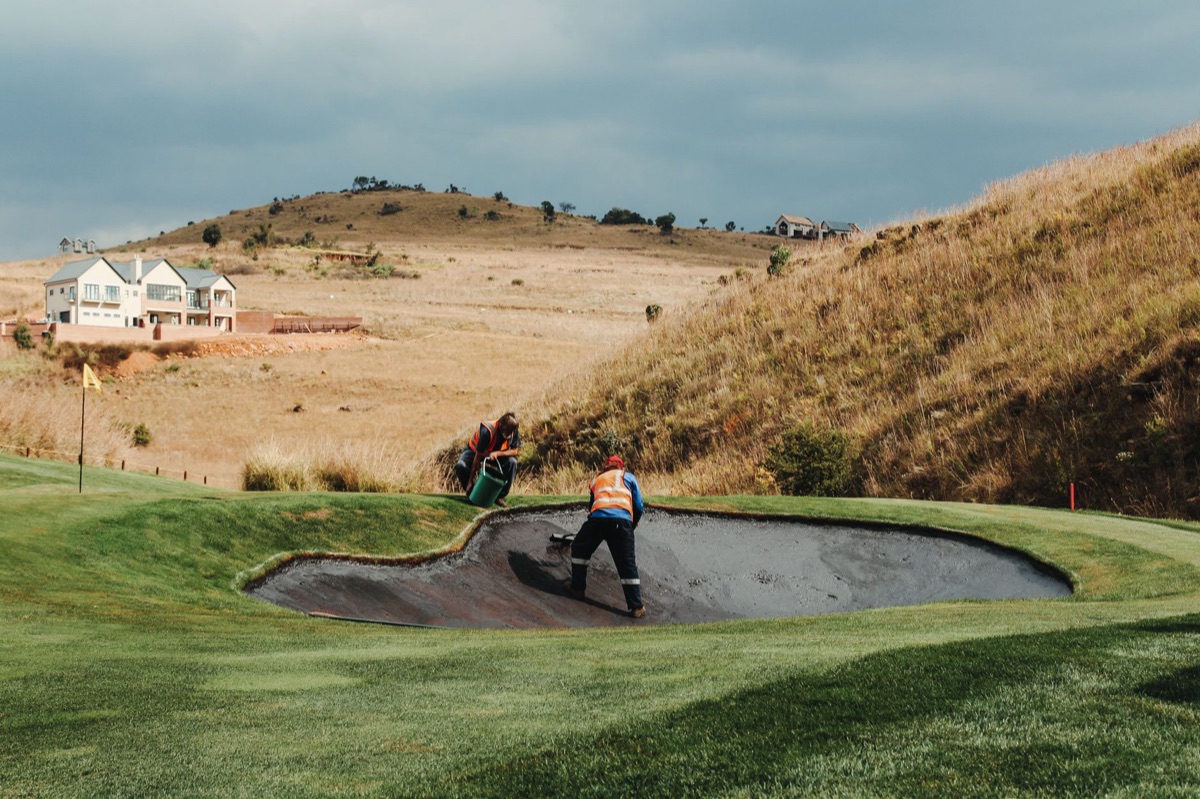 Golf course with maintenance crew