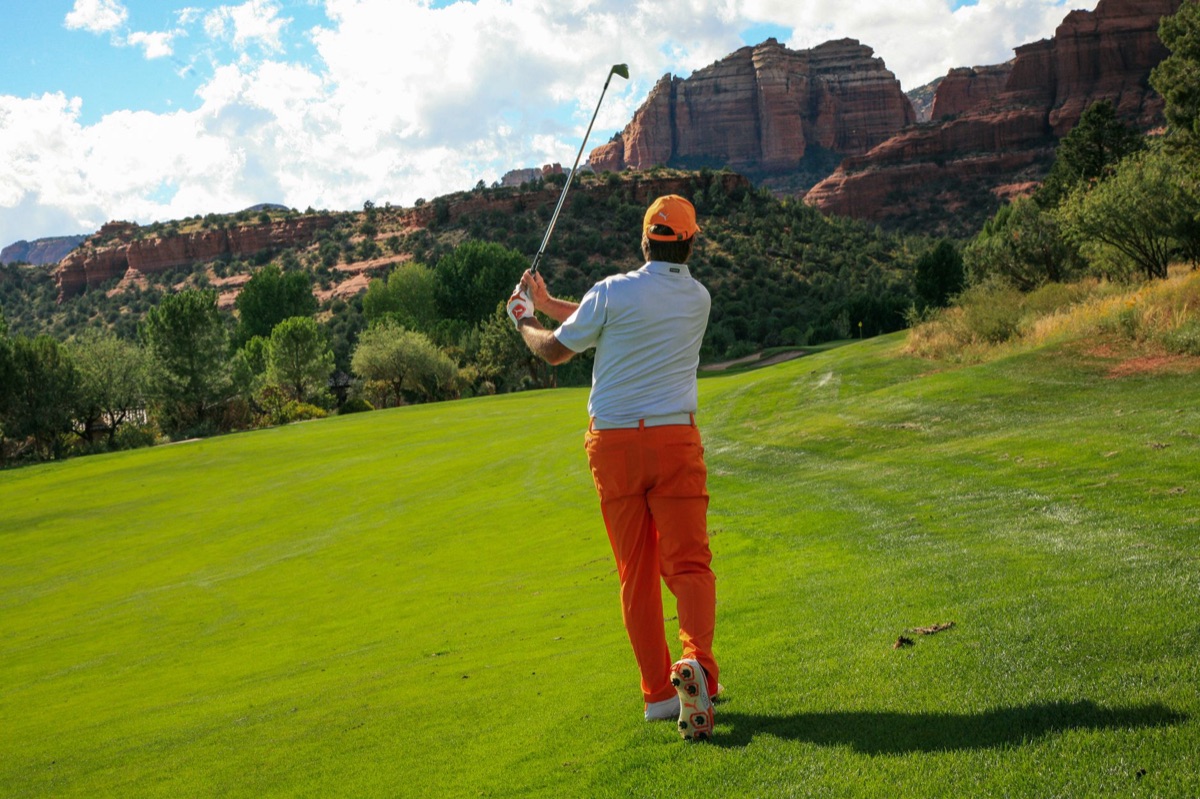 historic golf course flagstaff with ancient trees in the background